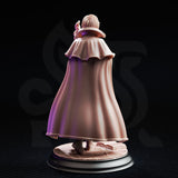 Lune de la Rue 32mm resin miniature by DM Stash — rear view of unpainted grey resin sculpt showing the full sweep of the academic cloak with layered folds and capelet, and the flagstone tome base visible beneath
