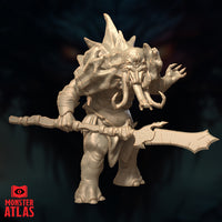 Slightly elevated front-angle digital render of the same unpainted Maelephant miniature, showing greater detail of the tusked face, spiked skull crown, reaching claw, and the finned polearm held horizontally. The textured hide and heavy limbs are clearly visible. Monster Atlas sculpt, 32mm scale.