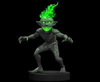 Digital render of the Magmin 1 MM2025 miniature by MZ4250 — a crouching goblinoid elemental creature with a wide jagged grin, hollow glowing green eyes, long clawed hands spread wide, and a dramatic crown of green flame erupting from its skull. Rocky, creviced skin texture throughout. Shown on a round black base against a black background.