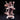 Horned female witch miniature gripping an orb-topped staff in one hand and raising a clawed hand skyward, wearing a tattered cloak with fur trim, standing on a skull-covered base. Sculpt by DM Stash.