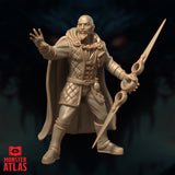 Bald bearded archmage miniature raising one open hand in a spellcasting gesture, holding an ornate ring-guard longsword at his side, wearing a quilted greatcoat and sweeping cape. Sculpt by Monster Atlas.