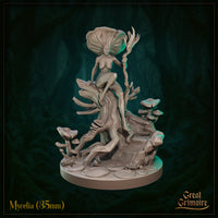 Front view of Mycelia 35mm resin miniature by Great Grimoire — an unpainted fungal fey figure with a broad mushroom cap head, seated on a gnarled tree stump and holding a twisted branch staff, surrounded by mushroom clusters and lily pads on a detailed scenic base