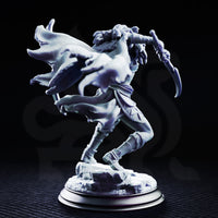 Drow female rogue lunging forward with twin curved blades, wearing skull-trimmed pauldrons and a scaled cloak swept back. Fine hair detail and skull bracers visible. Rocky base. Sculpt by DM Stash.