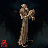 Nihiloor by Monster Atlas shown from a three-quarter angle emphasising the right side, ornate pauldron and arm plating prominent, the intellect devourer held outward with splayed clawed limbs visible, robes trailing to a frayed base.