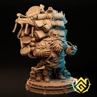 Digital render of Nuri on Holiday, an unpainted dwarf miniature by The Witchguild, shown in warm tan resin. The stocky dwarf stands on a cobblestone base with dwarven knotwork trim, straining under a towering load that includes rolled blankets, rope, a cookpot, a small barrel, leather satchels, and a padded armchair strapped to the top. He grips the load with one hand and holds a rope or strap in the other, his long braided beard prominent against his travel-worn coat.