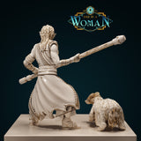 Digital render of Xira the Orc Monk miniature — rear view showing thick braided dreadlocks, knotwork-detailed robes, and the bear companion in a low stalking posture. Unpainted cream resin with gold accent highlights.
