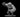 Grey resin digital render of the MM2025 Owlbear miniature — a large owl-bear hybrid creature in a crouching, forward-lunging pose with one taloned arm raised and claws extended, feathered chest and facial disc detailed, muscular bear-like limbs, mounted on a round base, 32mm scale