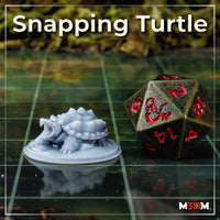 Unpainted grey resin Snapping Turtle miniature printed at 32mm scale, shown on a gaming grid beside a large metal d20 for scale reference, mouth open with jagged shell spikes clearly visible