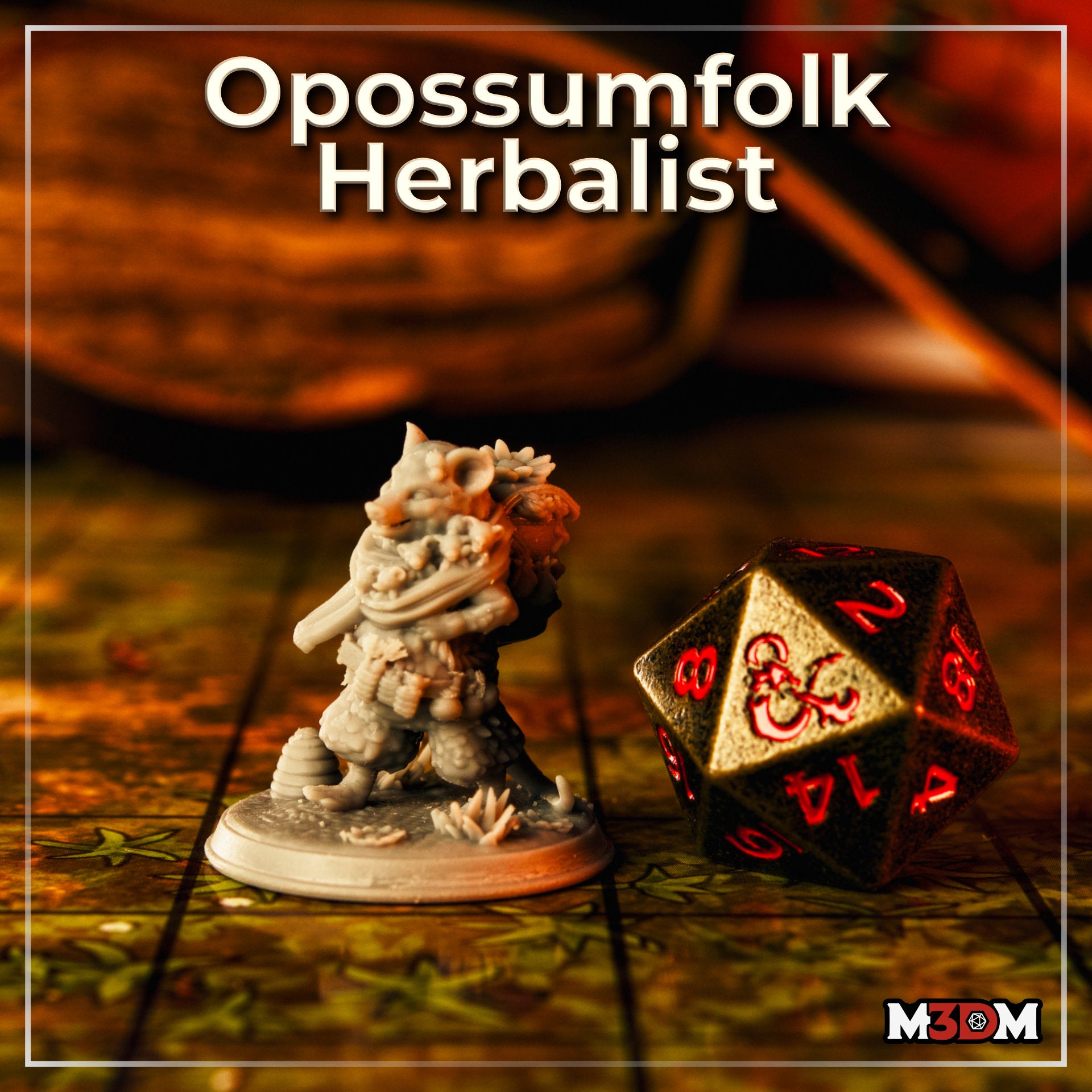 Photograph of the printed and unprimed Opossumfolk Herbalist miniature on a D&D battle mat alongside an oversized D20 die for scale — the 32mm grey resin mini shows strong detail in the joeys, scarf folds, and belt botanicals. M3DM branding visible in corner.