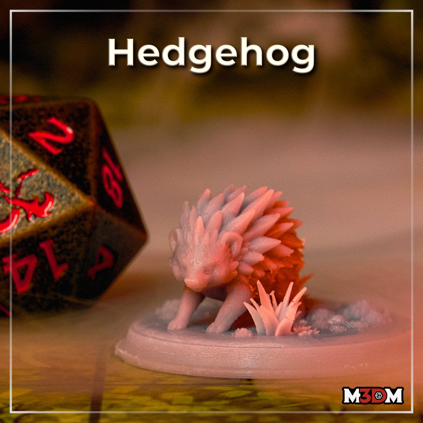 Unpainted grey resin hedgehog miniature by Mia Kay M3DM photographed on a tabletop beside a large D20 die, showing the sculpt's detailed layered quills and naturalistic base with small crystal and grass details at 32mm scale