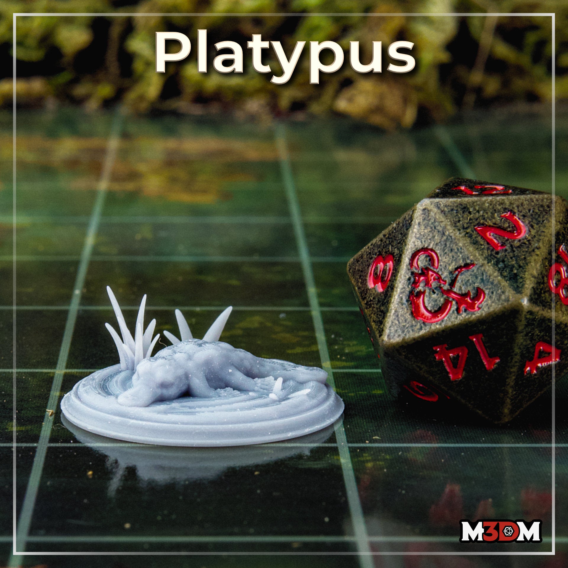 Unpainted grey resin platypus miniature printed at 32mm scale, shown on a gaming grid next to a large D&D d20 die for scale reference, with a blurred green foliage background
