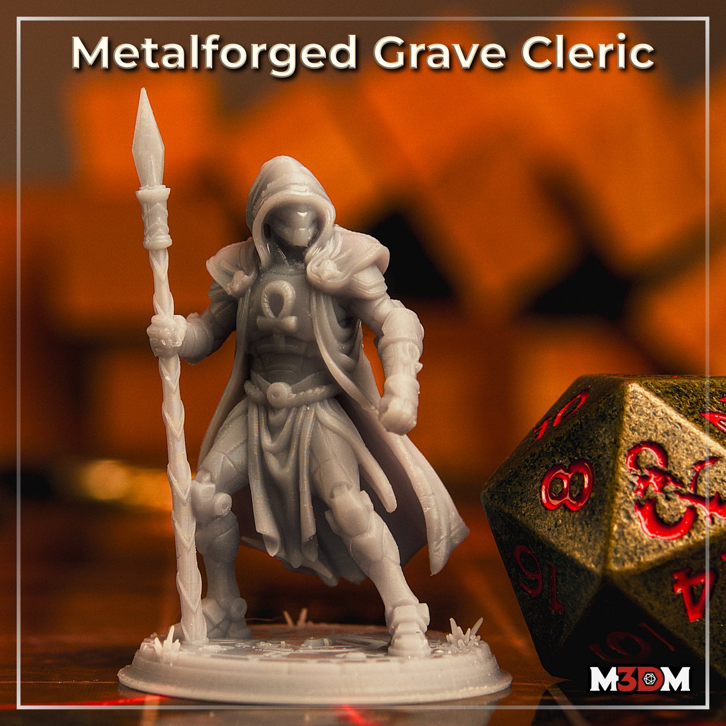 Photograph of an unpainted grey resin Metalforged Grave Cleric miniature printed at 32mm scale, showing the full sculpt with hooded masked face, ankh breastplate, flowing cloak, and spear-staff, pictured alongside a large bronze and red d20 die for scale reference