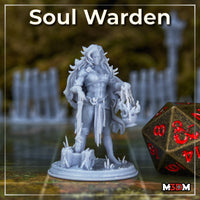 Unpainted grey resin Soul Warden miniature by Mia Kay M3DM photographed on a gaming table alongside a d20 — showing the 32mm scale figure with chain-bound forearms, soul lanterns, and crystalline scatter base elements