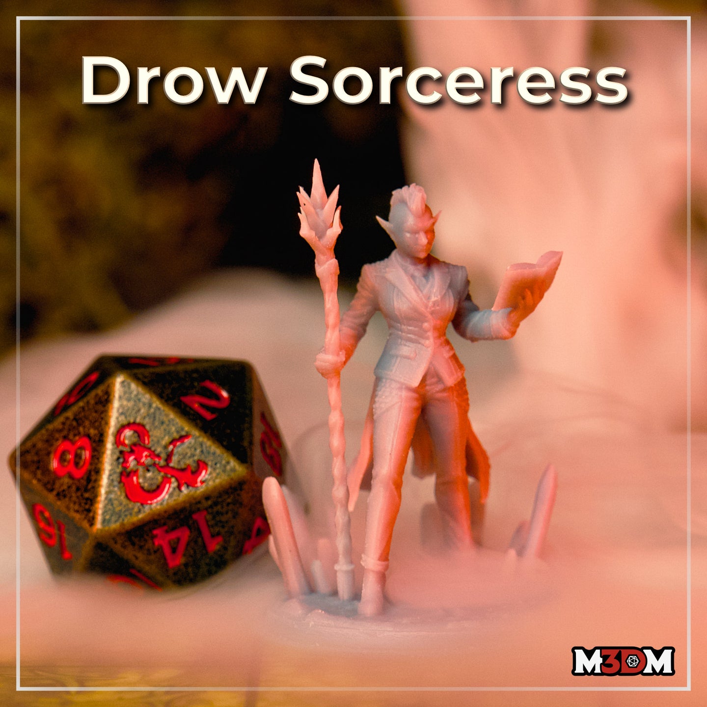 Photograph of a printed unpainted drow sorceress miniature beside a D&D d20 die for scale — the figure shows her confident stance with spiked staff raised and spellbook open, mounted on a crystal formation base