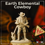 Photograph of an unpainted grey resin Earth Elemental Cowboy miniature on a gaming table beside a large gold-and-red D20 dice, showing the full sculpt with stone-textured coat, cowboy hat, rifle, and crystal base at 32mm scale