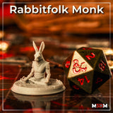 Photograph of a printed unpainted grey Harengon monk miniature in a seated meditation pose on a scenic base, shown next to a large dark green and red d20 die on a tabletop gaming surface