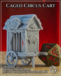 Photograph of the printed Caged Circus Cart terrain piece in unpainted grey resin, shown at 28mm scale alongside a large bronze D20 die for size reference, displaying the carved decorative facade, curtained cage bars, and wheeled base with draw-shaft
