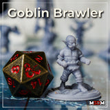 Stocky goblin brawler with raised fists and frilled wrist wraps, shown at tabletop scale beside a large d20 die, standing on a plain round base. Sculpt by Mia Kay M3DM.