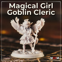 Goblin cleric miniature shown at small scale on a textured rocky base, wings spread wide, one arm raised, ruffled bow-trimmed skirt visible, halo overhead, tail curling. Sculpt by Mia Kay M3DM.