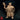 Front-facing render of Pikkel Bouldershoulder dwarf druid miniature, right hand raised open in a conjuring gesture, left hand gripping a gnarled leaf-topped staff, wearing runic robes, belted tabard, fur mantle, and a spiked crown with wild flame-like hair — unpainted gold resin