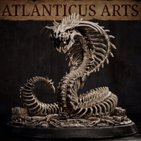 Bone Naga by Atlanticus Arts viewed from a lower angle, showing the full sweep of the articulated skeletal body, cranial spines, exposed fanged jaw, and detailed ossuary scatter base.