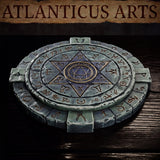 Top-down angled view of a circular stone summoning circle showing layered rune-etched tiers, a bold hexagram design across the inner disc, and a central sealed geometric motif surrounded by dense arcane script. Sculpt by Atlanticus Arts.