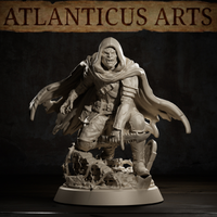 Snarling hooded vampire lord in a forward-leaning aggressive stance, tattered cloak torn at the hem, studded leg guards and cross-body leather straps, claw extended, base littered with broken stone and bone fragments. Sculpt by Atlanticus Arts.