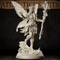 Fairy miniature with outstretched staff of budding wood, leaf-formed clothing, braided hair with foliage, and broad insect wings, posed mid-step on a detailed woodland debris base. Sculpt by Atlanticus Arts.