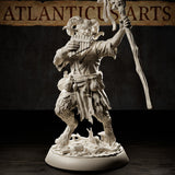 Satyr miniature with curved ram horns, smiling expression, playing pan pipes with one hand and raising a vine-wrapped staff with the other, tattered open shirt and belt of pouches at his waist, thick fur on his lower body, on a debris-strewn scenic base with mushrooms. Sculpt by Atlanticus Arts.