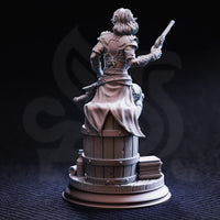 Rear view of Priscilia Stix miniature showing flowing coat, intricate back-lacing on the bodice, studded belt, sheathed dagger, and the detailed wood-grain and iron-banded barrel base with books and bottles