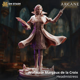 Digital render of Professor Margaux de la Croix miniature by DM Stash — an elven headmistress in a billowing quilted cloak, holding an open spellbook in one hand and a raised wand in the other, set against an arcane library background with the Arcane University logo visible