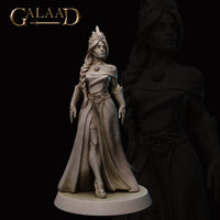 Front view of an unpainted grey resin miniature of a robed female figure with a horned headdress, long braided hair, off-shoulder flowing gown belted at the waist, and an open-handed standing pose on a round display base — Queen to Guard 01 by Galaad Miniatures