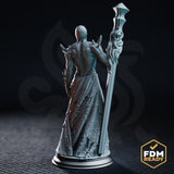 Close front view of the Awakened Priest of the Deep One, showing the intricate single cyclopean eye, exposed ribbed torso, layered torn robes, and the staff topped with a geometric angular head. DM Stash sculpt.