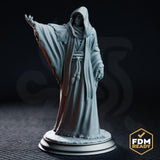 Hooded cultist in long tattered robes, one arm raised with splayed clawed fingers, grinning sunken face visible beneath the cowl, rope belt at waist, standing on a cracked scenic base. Sculpt by DM Stash.