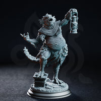 Bloated fish-headed aberration standing on one taloned foot, raising a battered lantern in one clawed hand while the other reaches outward with splayed claws. Wrapped in ragged cloth and chain, the bulging torso is covered in pustules and scales. Sculpt by DM Stash.