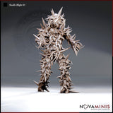 Digital render of Needle Blight 01 miniature by Novaminis — front view showing an upright humanoid creature covered in sharp outward-facing spines, coiling tendrils, and a hollow fang-lined maw, rendered in unpainted grey-brown resin tone at 32mm scale