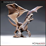 Unpainted resin miniature of a Green Dragon Wyrmling in a rearing pose with wings spread wide, open jaws showing sharp teeth, and claws splayed forward — 32mm scale D&D miniature by Novaminis