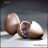 Digital render of Dragon Eggs 02 by Novaminis — one intact textured dragon egg and one cracked open hatching egg with jagged shell edges and a dark hollow interior, viewed from a close front angle