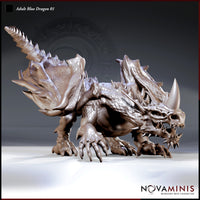 Adult Blue Dragon 01 by Novaminis: a massive dragon in a low prowling stance, body pressed forward, clawed feet splayed wide, wings folded tight, spiralling horn rising from the skull, fanged jaw open.