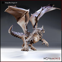 Young Blue Dragon miniature by Novaminis — lunging pose with wings fully spread, jaws open and snarling, forelegs outstretched with claws splayed, segmented tail with dorsal spines curling behind.