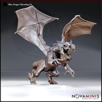 Blue Dragon Wyrmling 03 by Novaminis — ferocious small dragon rearing up on hind legs, wings spread wide, jaws open, clawed forelimbs raised aggressively, detailed scale and membrane texture throughout.