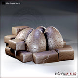 Three large dragon eggs with hexagonal scale texture, clustered among rough worn stone blocks. Each egg leans at a slightly different angle. Sculpt by Novaminis.