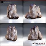 Four angles of a craggy three-pillar rock cluster showing its broad, low base mass and deeply grooved crevices between columns. Rough, uneven surface texture visible across all faces. Sculpt by Novaminis.
