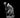 Unpainted grey resin digital render of a Ratfolk Warlock miniature at 32mm scale, depicted in a low crouching pose wearing layered hooded robes with serpentine detailing, holding a tall gnarled staff topped with a horned skull, with rat-folk features including rounded ears, flat muzzle, and bare clawed feet, on a flat round base