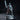 Grinning male figure in a long coat raising a serrated bone saw overhead, one knee propped up, standing on a crumpled cloth base. Sculpt by DM Stash.