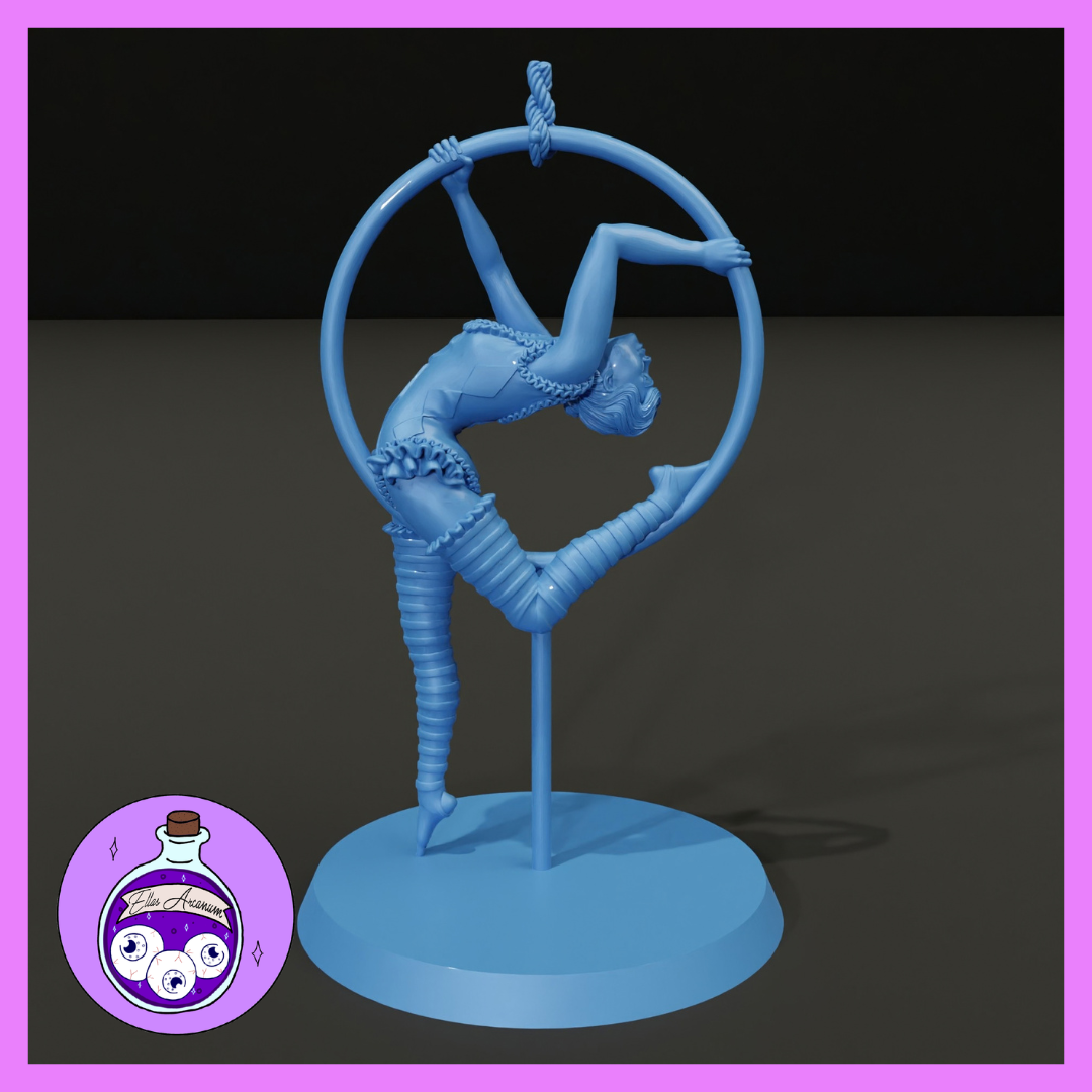 Female acrobat contorted through a large suspended hoop, body in a deep backbend with legs split wide, wearing a ruffled costume with chain trim and wrapped leg bindings. Sculpt by Ella's Arcanum Minis.