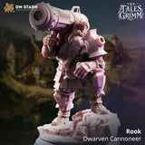 Rear view of a dwarven cannoneer miniature showing the barrel end of a shoulder cannon, broad plate armour across the back, articulated leg guards, and a textured rocky base. By DM Stash.