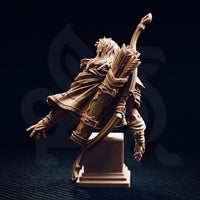 Rear three-quarter view of the Sactarin Sun Elf Tracker bust, showing the feather-fletched quiver, flowing hair, detailed cloak draping, and layered armour across the back, mounted on a stepped stone base
