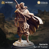 Front three-quarter render of Sactarin the Sun Elf Tracker miniature — an unpainted resin figure in flowing traveller's attire with ornate pauldrons, a recurve longbow across his back, and a billowing cape, standing on a rocky terrain base. DM Stash Elves of the Golden Sun range.