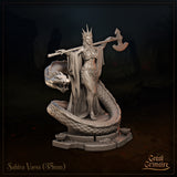 Three-quarter front view of Sahira Vaess 35mm resin miniature by Great Grimoire — unpainted grey resin, showing the spiked crown, billowing cloak, ornate scale-work skirt, and the serpent familiar with its fanged head raised beside her, great axe raised behind her opposite shoulder